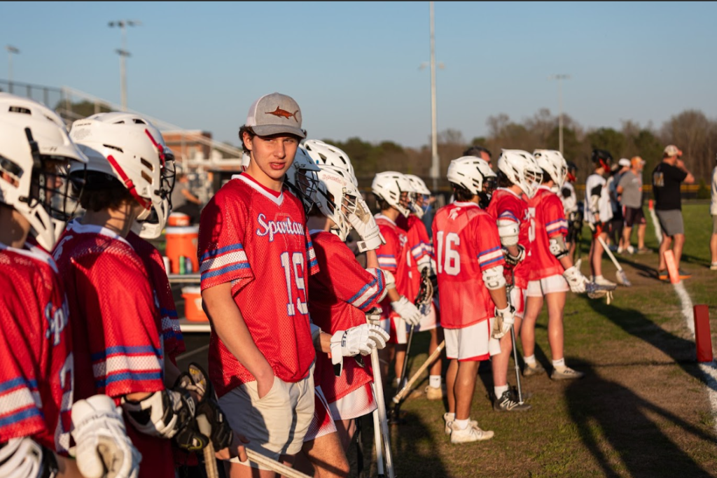 A close-up shot of the Sanderson High School lacrosse team on the sideline.