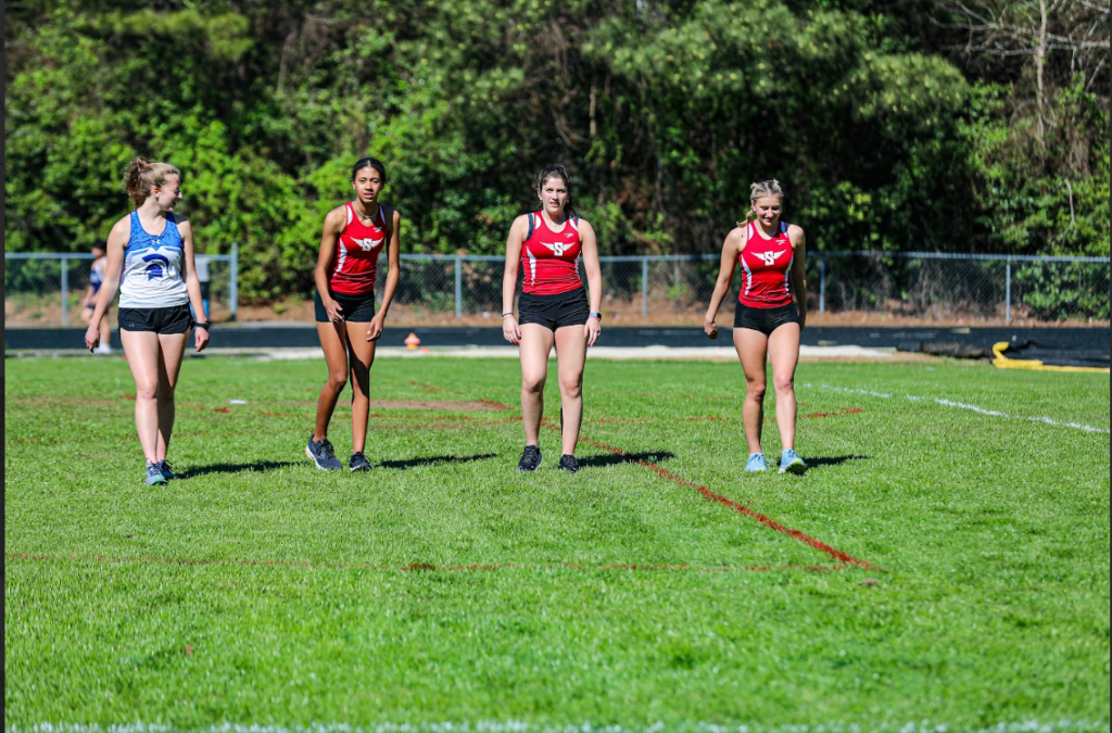 3 Sanderson track runners lining up on the field.